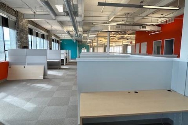 Empty office with cubicle workstations, orange and teal accent walls, and large windows. - 202 - 109 Vanderhoof Avenue, Toronto