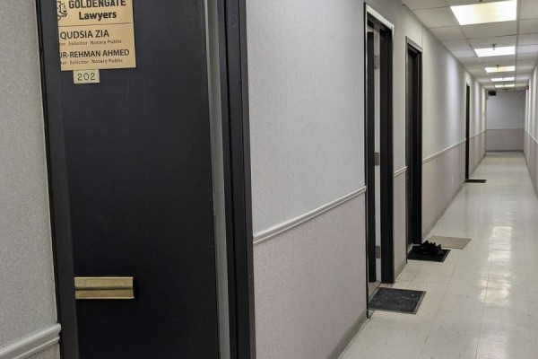 Office hallway with multiple doors and a light-colored floor. - 202 - 1150 Eglinton Avenue E, Mississauga