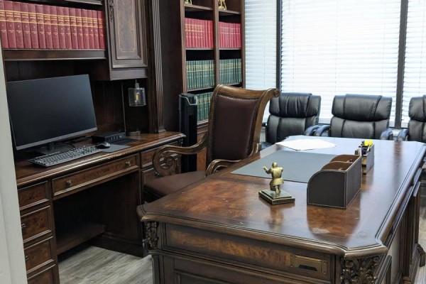 Executive desk in a lawyer's office with a computer and ornate wooden trim. - 202 - 1150 Eglinton Avenue E, Mississauga