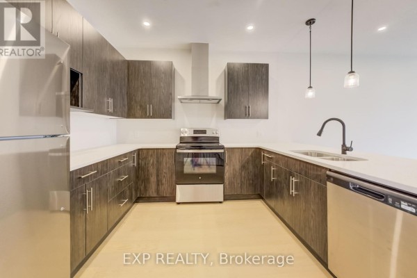 Spacious kitchen featuring dark cabinetry and open layout - 202 - 12 Washington Street, Norwich