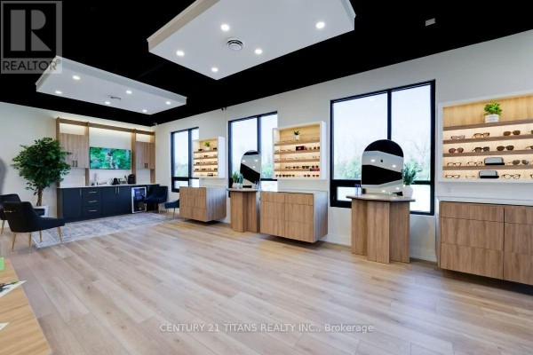 Commercial space interior showing multiple display units for eyewear and seating areas. - 202 - 40 Blowers Crescent, Ajax