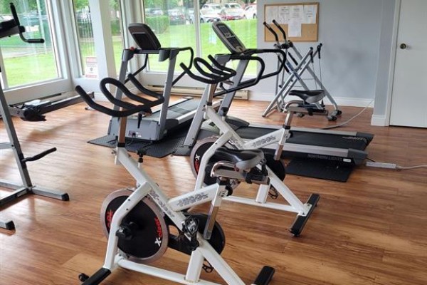 Interior view of a small gym with treadmills, stationary bikes, and exercise equipment. - 202 - 860 Commissioners Road E, London South