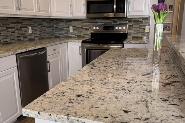 Open kitchen layout featuring white cabinetry and modern appliances - 202 111 Richmond Street, Charlottetown