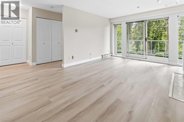 Interior common area with seating, large windows, and natural light. - 202 1148 Westwood Street, Coquitlam