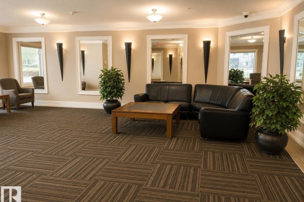 Apartment building lobby with black leather couches, wooden coffee table, and large mirrors. - #202 16715 100 Av Nw, Edmonton