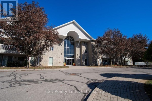 Front entrance of the apartment building with stone facade and arched windows. - 202 C - 1099 Clonsilla Avenue, Peterborough