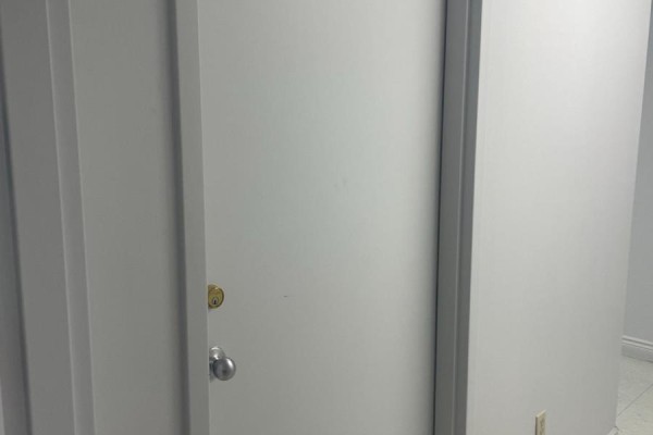 Interior view of a plain white door with a silver doorknob and lock. - 202 Rear - 13 Grange Avenue, Toronto