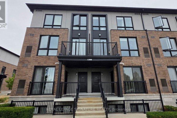 Front facade of a townhouse building with brick, metal, and windows. - 203 - 1208 Main St East Street, Milton