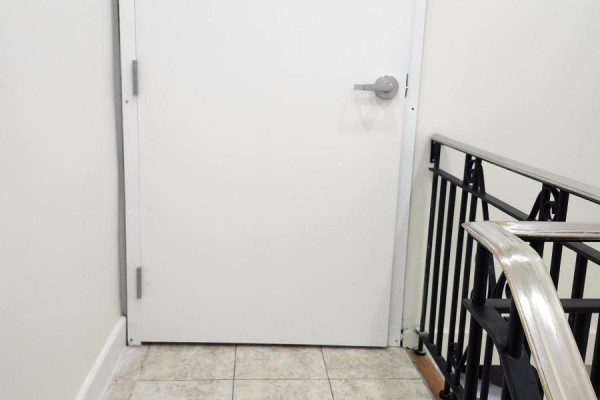 Closed door at the top of the stairs with tile flooring - 203 - 357 Main Street E, Hamilton