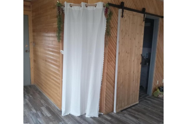 Curtained entry to a private area with wooden walls and sliding door. - #203 60331 Range Road 124, Rural Smoky Lake County