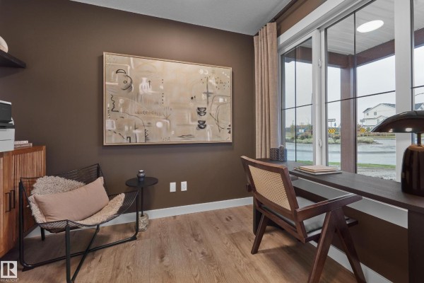 Open concept kitchen and living area with island, seating, and modern finishes. - 2032 Marquis Wy Ne, Edmonton