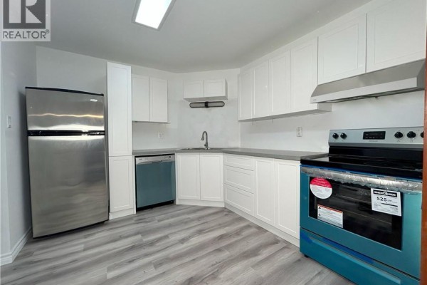 White kitchen with stainless steel appliances, gray countertops, and ample cabinet space. - 2035 South Millway End Unit# 62, Mississauga