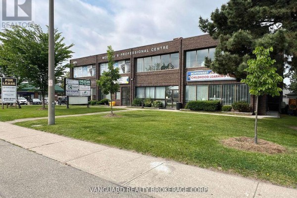Side view of the building showcasing large windows and landscaping. - 204 - 2978 Islington Avenue, Toronto