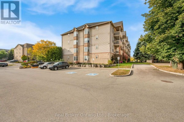 Parking lot with accessible spaces beside an apartment building. - 204 - 4015 Kilmer Drive, Burlington