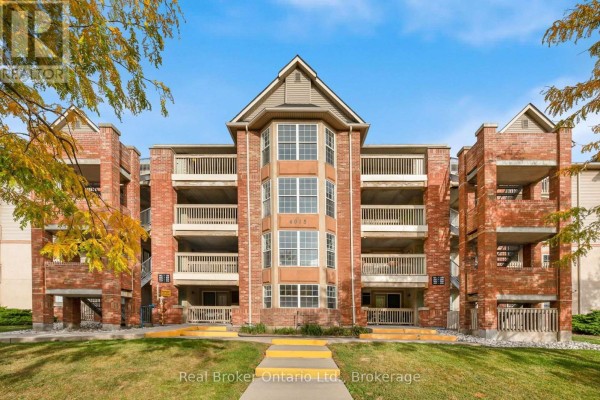 Front facade of a four-story brick apartment building with balconies. - 204 - 4015 Kilmer Drive, Burlington