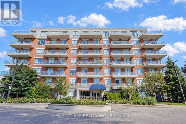 A wide view of a red brick apartment building with many balconies and trees. - 204 - 777 Steeles Avenue W, Toronto