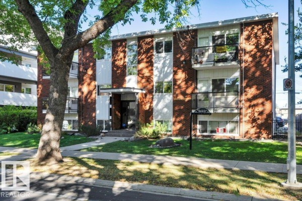 Another angle of the apartment building exterior, highlighting the brick facade and windows. - #204 10540 80 Av Nw, Edmonton