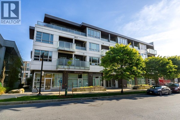 Angle of the apartment building exterior showing multiple floors and balconies. - 204 711 W 14th Street, North Vancouver