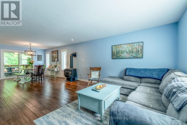 Living room with wood stove and sectional sofa - 204 Golf Course Road Wasaga Beach