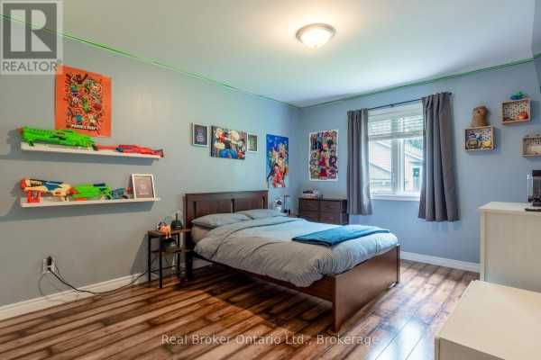Bedroom with toy guns, posters, and a fish tank - 204 Golf Course Road Wasaga Beach