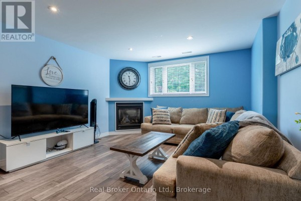 Living room with fireplace and sectional sofa - 204 Golf Course Road Wasaga Beach