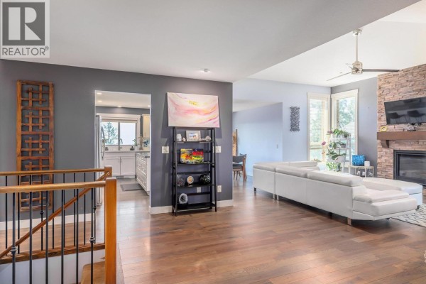 Open concept living area with a kitchen view and staircase. - 2040 Rosealee Lane Unit# 35, West Kelowna