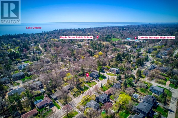Aerial view of a residential neighborhood with Oakville Trafalgar High School and Lake Ontario nearby. - 2048 Devon Road, Oakville