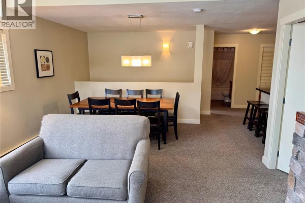 Kitchen with granite island, wood cabinets, and stainless steel appliances. - 2049 Summit Drive Unit# 225c, Panorama Mountain
