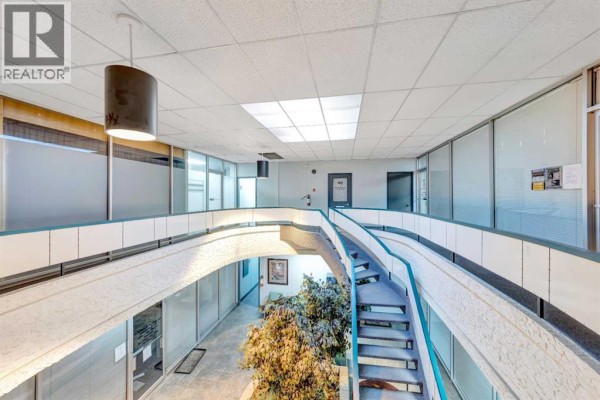 View from the second floor of the interior atrium, showing stairs and offices below. - 205, 5009 48 Street, Lloydminster