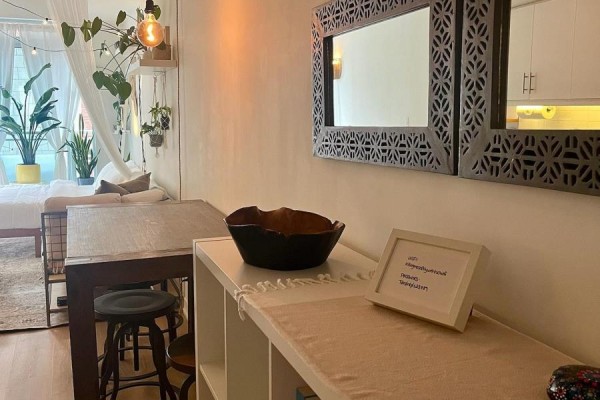 Close-up of a dining table and shelf with decorative items and mirrors on the wall. - 205 - 10 Willison Square, Toronto