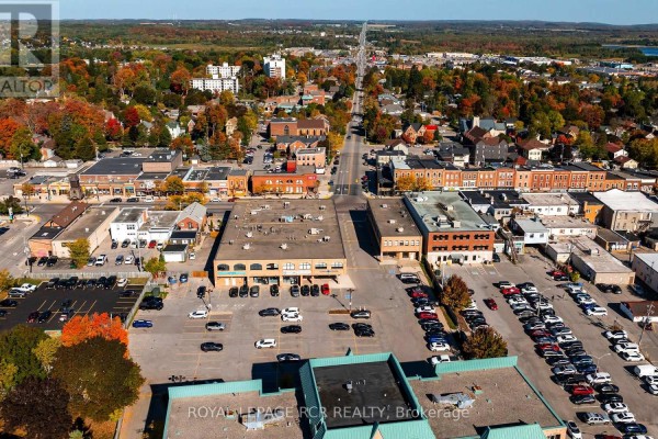 Aerial view of commercial building and downtown Orangeville with distant lake. - 205 - 190 Broadway, Orangeville