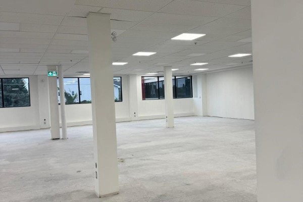 Spacious, unfinished commercial interior with concrete floor and white support columns. - 205 - 31 Northside Road, Ottawa