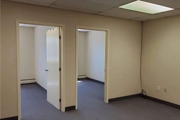 Office room with a large window showing the exterior and a radiator below. - 205 - 35 The Links Road, Toronto