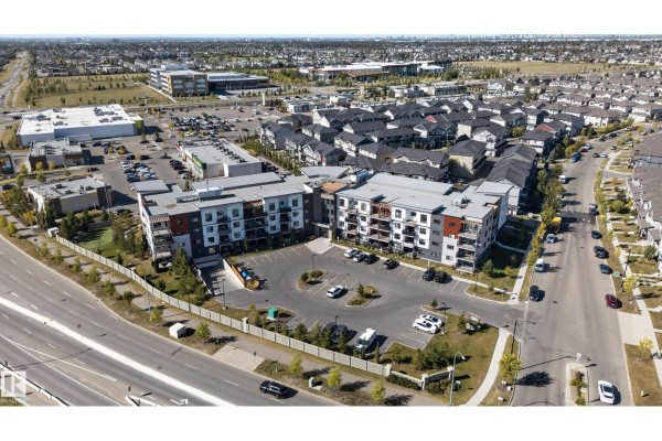 High aerial view of the apartment building complex bordered by a highway and residential areas. - #205 1506 Tamarack Bv Nw, Edmonton