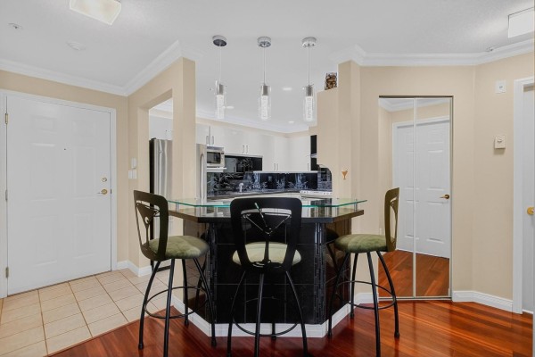 Floor plan of a two-bedroom apartment with a balcony and laundry area. - 205 15140 29a Avenue, Surrey