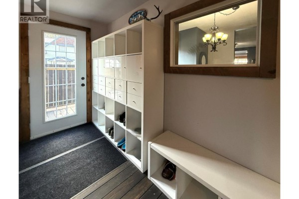 Spacious living area with a sectional sofa, dining area, and spiral staircase - 205 Otis Street, Kimberley