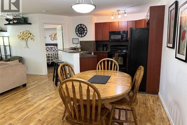 Aerial view of apartment buildings with parking lots and green spaces. - 205 Third Avenue Unit# 2219, Invermere