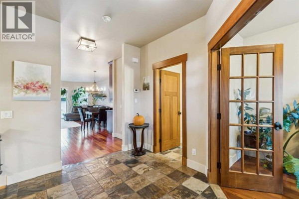 Interior foyer looking towards an office and a dining area with wood floors. - 2050 47 Avenue Sw, Calgary