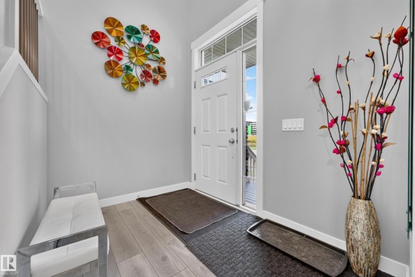Kitchen with gray wood cabinets, stainless steel microwave, coffee maker, and white subway tile backsplash. - 20503 99 Av Nw, Edmonton