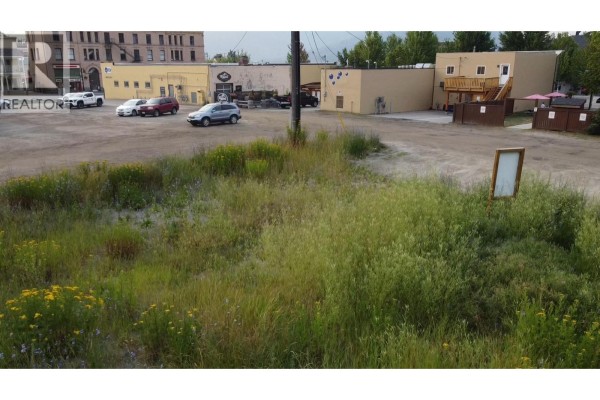 Close-up aerial view of the lot, highlighting uneven terrain and surrounding vegetation. - 2054 Spokane Street Lot# 1, Rossland