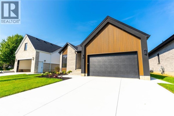 Side view of a modern detached house with brick and wood facade. - 2056 Marion Avenue, Sarnia