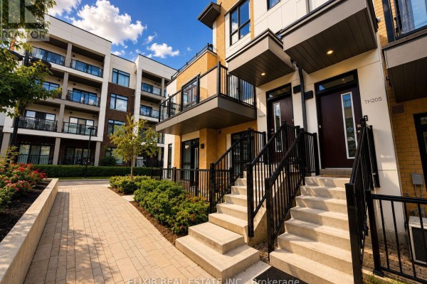 Exterior view of townhouse entrances with stairs, railings, and balconies. - 206 - 140 Canon Jackson Drive, Toronto