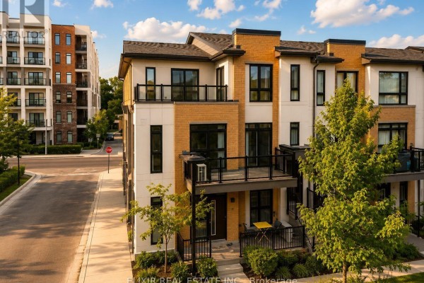 Front view of modern townhouses with balconies and trees along the street. - 206 - 140 Canon Jackson Drive, Toronto