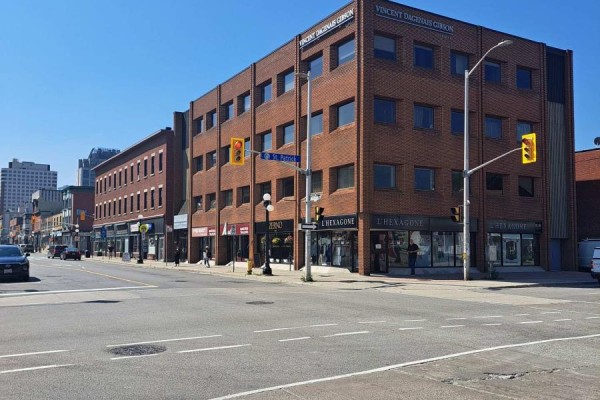 Exterior view of a brick commercial building with multiple storefronts on a city street. - 206 - 260 Dalhousie Street, Ottawa