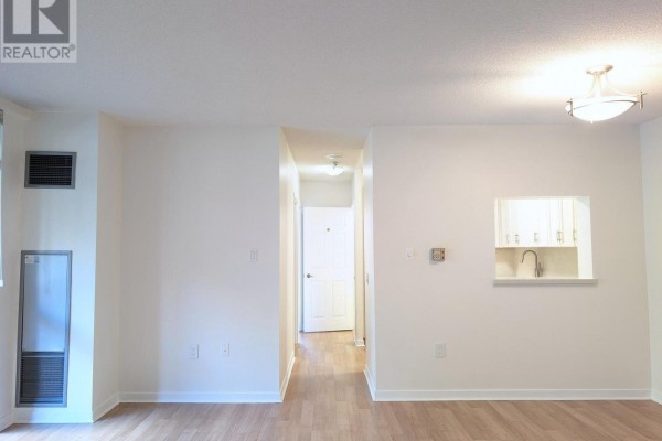 Open concept living and dining area with furniture, balcony view, and modern light fixture. - 206 - 284 Bloor Street W, Toronto