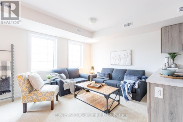 View from the dining area towards the open-concept kitchen and living space. - 206 - 48 Maple Avenue, Asphodel Norwood