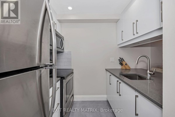 View of kitchen counter, sink, and white cabinets from the side. - 206 - 6532 Bilberry Drive, Ottawa