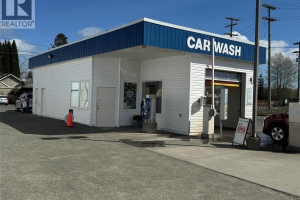 Front view of the car wash building with a red car approaching the wash bay and "OPEN" sign. - 2060 Island Hwy, Campbell River