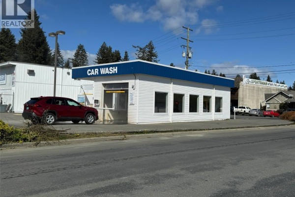 Street view of the car wash building with white siding, blue trim, and several cars parked nearby. - 2060 Island Hwy, Campbell River