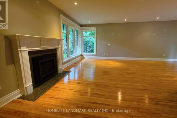 Living room with a fireplace, bay windows, and hardwood floors. - 2062 Glenforest Crescent, Oakville